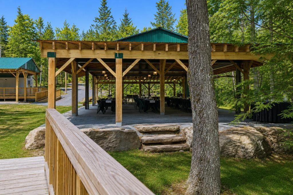 Lush outdoor event space with woodland backdrop
